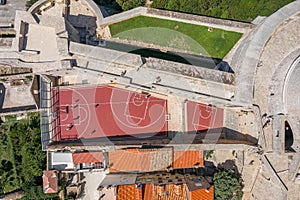 Aerial overhead drone shot of basketball court by Fort Minceta of Dubrovnik city wall in Croatia summer