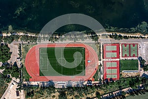 Aerial overhead drone shot of football field, tennis and basketball court in Argostolion, on Kefalonia Island