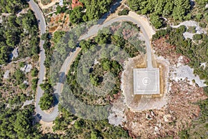 Aerial overhead drone shot of helipad heliport on hill of Vis Island in Adriatic sea in Croatia summer time