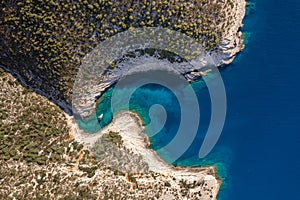 Aerial overhead drone shot of yacht on Adriatic sea curvy cove on Vis Island in Croatia summer morning photo