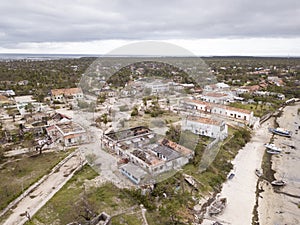 Aerial overhead houses on a tropical island, damaged by a cyclone