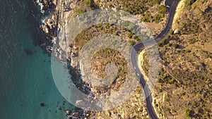 Aerial overhead a rocky coastline with dramatic road