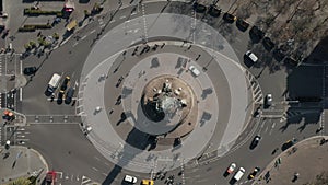 Aerial: overhead shot of Columbus monument roundabout in Barcelona, Spain with busy car traffic on sunny day