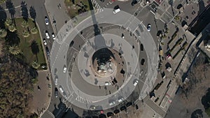 Aerial: overhead shot of Columbus monument roundabout in Barcelona, Spain with busy car traffic on sunny day