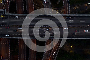 Aerial overhead shot of flyover highway traffic before dawn in Chongqing, China