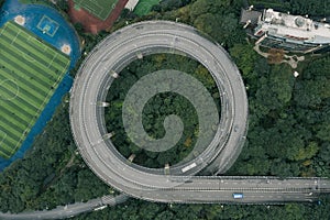 Aerial overhead shot of particular double circle 720 degree flyover in bushes residential buildings in Chongqing, China