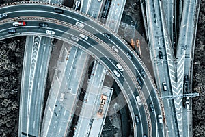 Aerial overhead view of a highway and an overpass in a city on a gloomy day