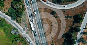 Aerial overlooking the hiway with cars, trucks and other transport.