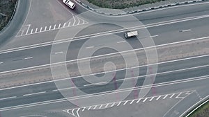 Aerial overlooking the hiway with cars, trucks and other transport.