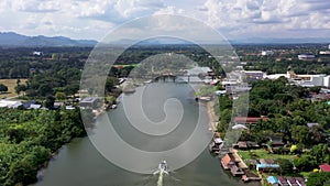 Aerial overview and descending flight at the Kwai noi river and surrounding landscape in the Kanchanaburi province