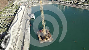 Aerial pan of Passeo del Muelle Dos pedestrian promenade Malaga, Spain