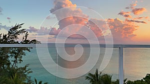 An aerial pan view of Cemetery Beach in Grand Cayman Island with a beautiful sunset