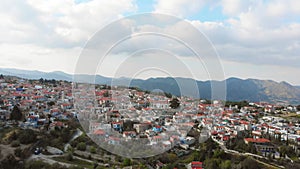 Aerial pan view popular tourist attraction Pano Lefkara village on Cyprus, Europe. Flying over majestic cityscape with greek
