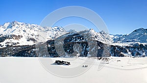 Aerial panoram of the Chaviolas islets and Isola with people doing sports on the frozen lake