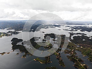 Aerial panorama of artifical lake water reservoir dam Embalse Penol Guatape at Penon rock monolith in Antioquia Colombia