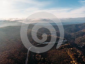 Aerial panorama of asphalt road in mountain landscape, drone view from above, travel and journey