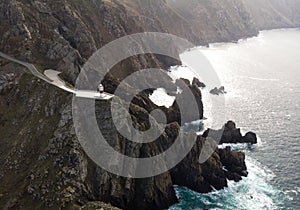 Aerial panorama of Cabo Ortegal lighthouse on steep rocky cliff atlantic ocean bay of biscay Carino Cape Galicia Spain photo