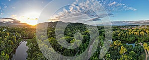 Aerial panorama of Cairns Botanical garden at sunset showing the rainforrest and Cairns city