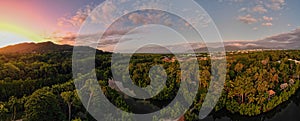 Aerial panorama of Cairns Botanical garden at sunset showing the rainforrest and orange and red sky