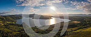 Aerial panorama of Caragh Lake in County Kerry with the sun setting over the lake