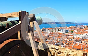 Aerial panorama of the city of Lisbon seen from the castle Castelo de Sao Jorge with a canon