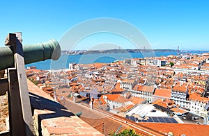 Aerial panorama of the city of Lisbon seen from the castle Castelo de Sao Jorge with a canon