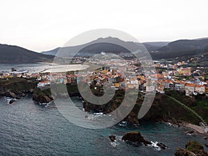 Aerial panorama of cliff houses buildings in spanish seaside atlantic ocean town village city Carino Galicia Spain