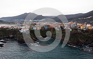 Aerial panorama of cliff houses buildings in spanish seaside atlantic ocean town village city Carino Galicia Spain photo