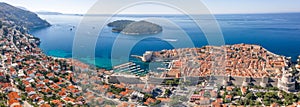 Aerial panorama drone shot of Dubrovink city old town port with view of Lokrum island in Croatia summer morning