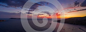 Aerial panorama drone shot of sunset burning sky clouds on Komiza town over Vis Island in Croatia Summer