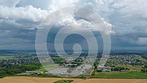 Aerial panorama. Golden agricultural field. Small town on the horizon.