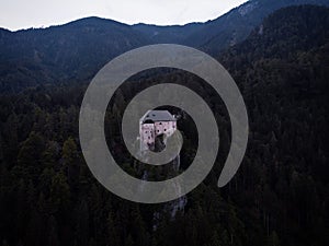 Aerial panorama of idyllic medieval historic stone rock hill cliff edge castle Schloss Stein in Dellach Kaernten Austria