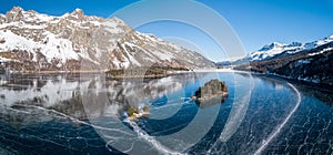 Aerial panorama image of the Chaviolas islets on the frozen lake of Silsersee photo