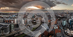 Aerial panorama of Leeds Dock and River Aire in a cityscape skyline at sunrise