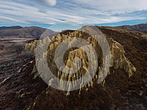 Aerial panorama of Omarama Clay Cliffs geological natural erosion silt and sand rock formation in Canterbury New Zealand