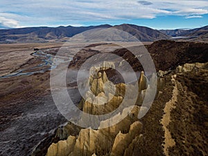 Aerial panorama of Omarama Clay Cliffs geological natural erosion silt and sand rock formation in Canterbury New Zealand