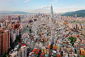 Aerial panorama over Downtown Taipei, capital city of Taiwan with view of prominent Taipei 101 Tower amid skyscrapers