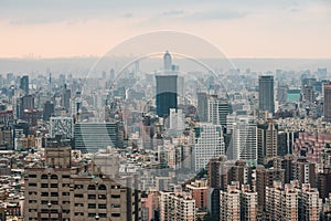 Aerial panorama over Downtown Taipei with layers of mountain in background in the dusk from Xiangshan Elephant Mountain.