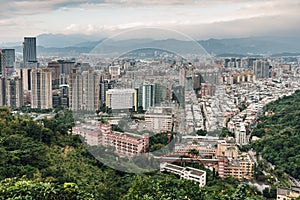 Aerial panorama over Downtown Taipei with layers of mountain in background in the dusk from Xiangshan Elephant Mountain.