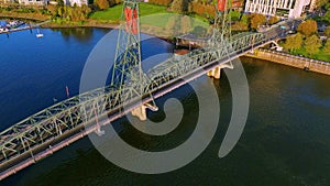 Aerial panorama of Portland\'s Hawthorne Bridge, iconic buildings, and elegant camera moves just after sunrise.