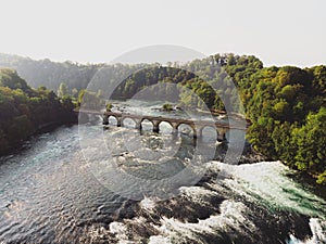 Aerial panorama of railway railroad arch bridge at Rheinfall waterfall on Rhine river Neuhausen Schaffhausen Switzerland