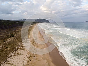 Aerial panorama of sand coast pacific ocean sea shore Opoutere beach waves Waikato Coromandel Peninsula New Zealand