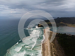 Aerial panorama of sand coast pacific ocean sea shore Opoutere beach waves Waikato Coromandel Peninsula New Zealand