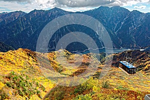 Aerial panorama of a scenic cable car flying over the beautiful autumn valley in Tateyama Kurobe Alpine Route, Toyama Japan