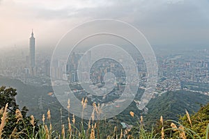 Aerial panorama of Taipei City at foggy dusk with view of Taipei buildings in downtown area