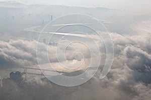 Aerial panorama of Taipei City on a foggy morning with a bird`s eye view of dense fog rolling over Guandu Plain