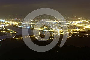 Aerial panorama of Taipei City in a misty gloomy night, with view of Guandu plain, Tamsui River and downtown area