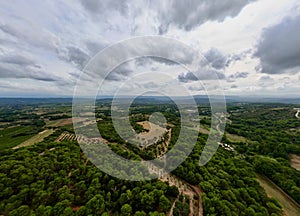 Aerial Panorama between Vaugines and Cucuron: Cloudy Skies Over Ancient and New Forests in PACA, Provence