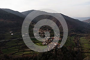 Aerial panorama view of green agriculture farming terraces in remote rural mountain village town Sistelo Norte Portugal