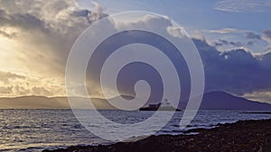 Aerial panorama view of the historic Fenit Lighthouse in Tralee Bay, beautiful clouds, sunset